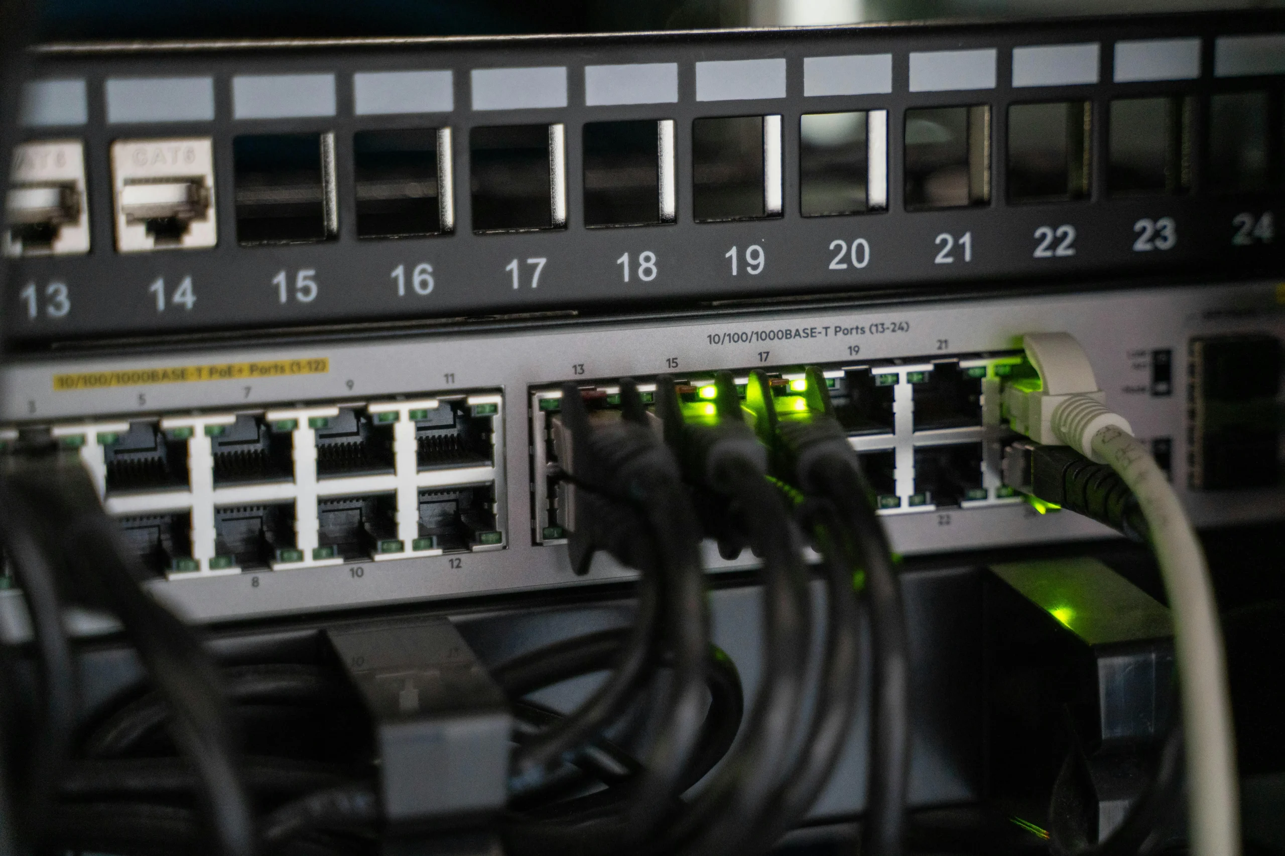 Close-up of network cables and Ethernet ports symbolizing connected communication channels and centralized inbox management.